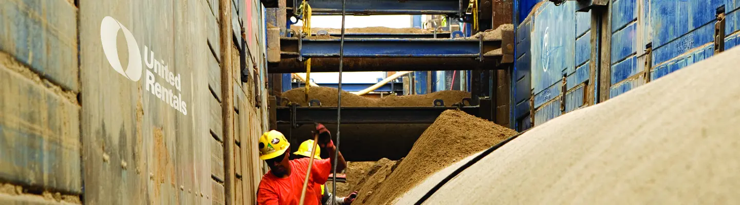 two men in trench wearing ppe
