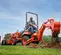 Orange and black KUBOTA 20-29 HP Backhoe Loader, 8 ft. profondeur de creusement