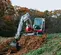 Red and white Takeuchi Mini Excavator with Reduced Tail Swing