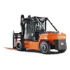 Rear angled view of an orange and black Toyota warehouse forklift with a black mast and orange forks with an enclosed cabin.