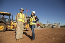 man and woman on construction site in PPE 