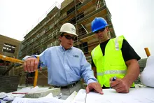two men in hard hats on construction site
