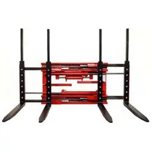 Front view of a red double forklift attachment with two sets of black forks extended.