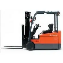 Side view of an orange and black Toyota warehouse forklift with a black mast, black forks and an open cabin.